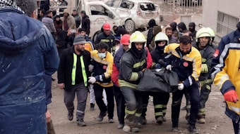 Feuerwehrleute tragen die Leiche eines Opfers in Diyarbakir vom Unglücksort weg. Derzeit sind nach offiziellen Angaben mehr als 900 Menschen durch die Erdbeben ums Leben gekommen.