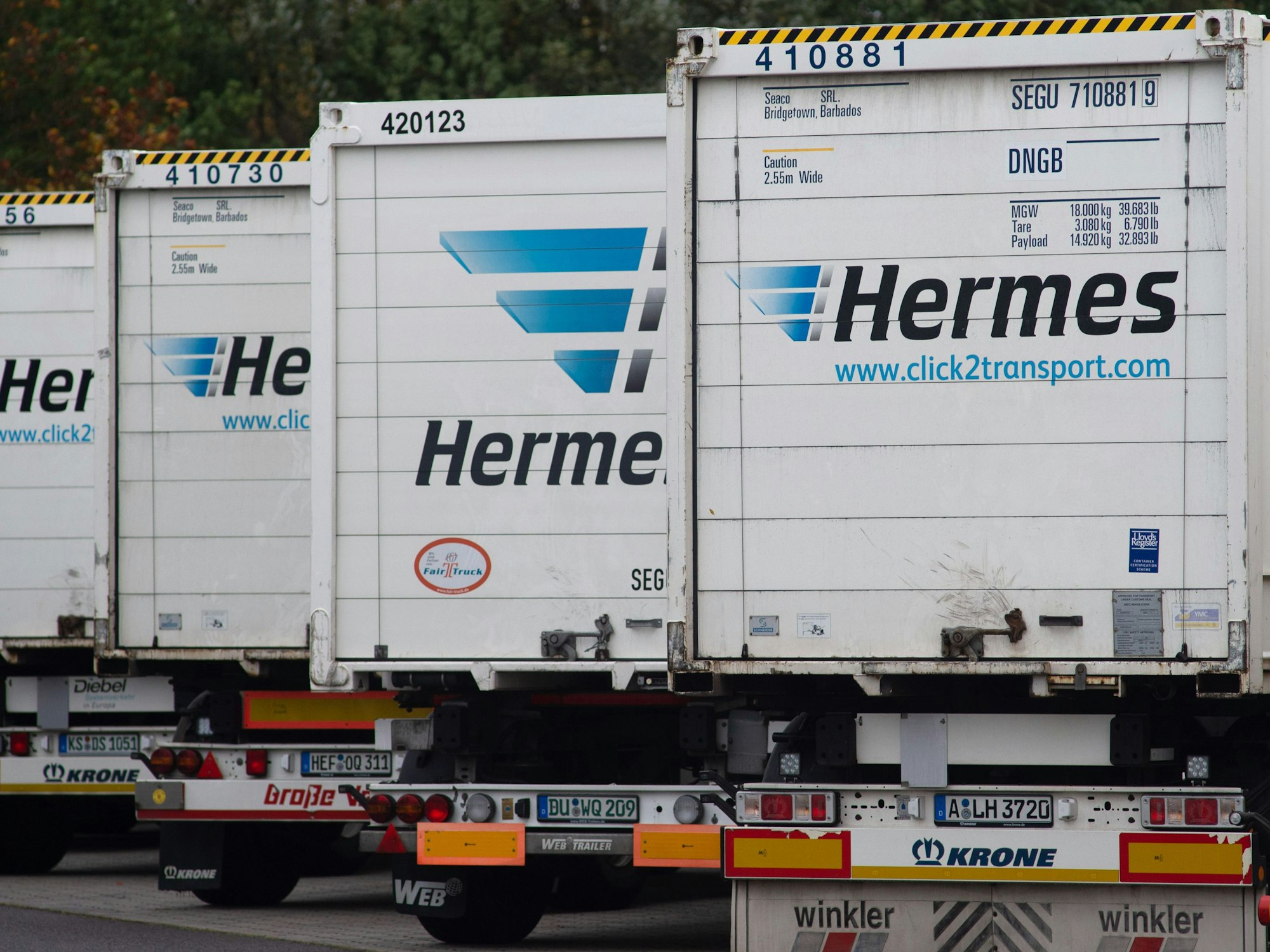 Hermes-Lastwagen stehen auf dem LKW-Parkplatz vor dem Tor des Versandzentrums des Paketdienstleisters Hermes dicht an dicht.
