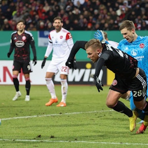 Rouwen Hennings von Fortuna Düsseldorf geht im Strafraum des 1. FC Nürnberg zu Boden.