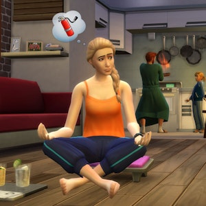 Das Symbolfoto aus dem Jahr 2021 zeigt eine Szene aus dem Spiel „Sims“. Zu sehen ist ein weiblicher Charakter, der in Yogahaltung auf dem Boden sitzt. Im Hintergrund stehen zwei weitere Sims am Herd.