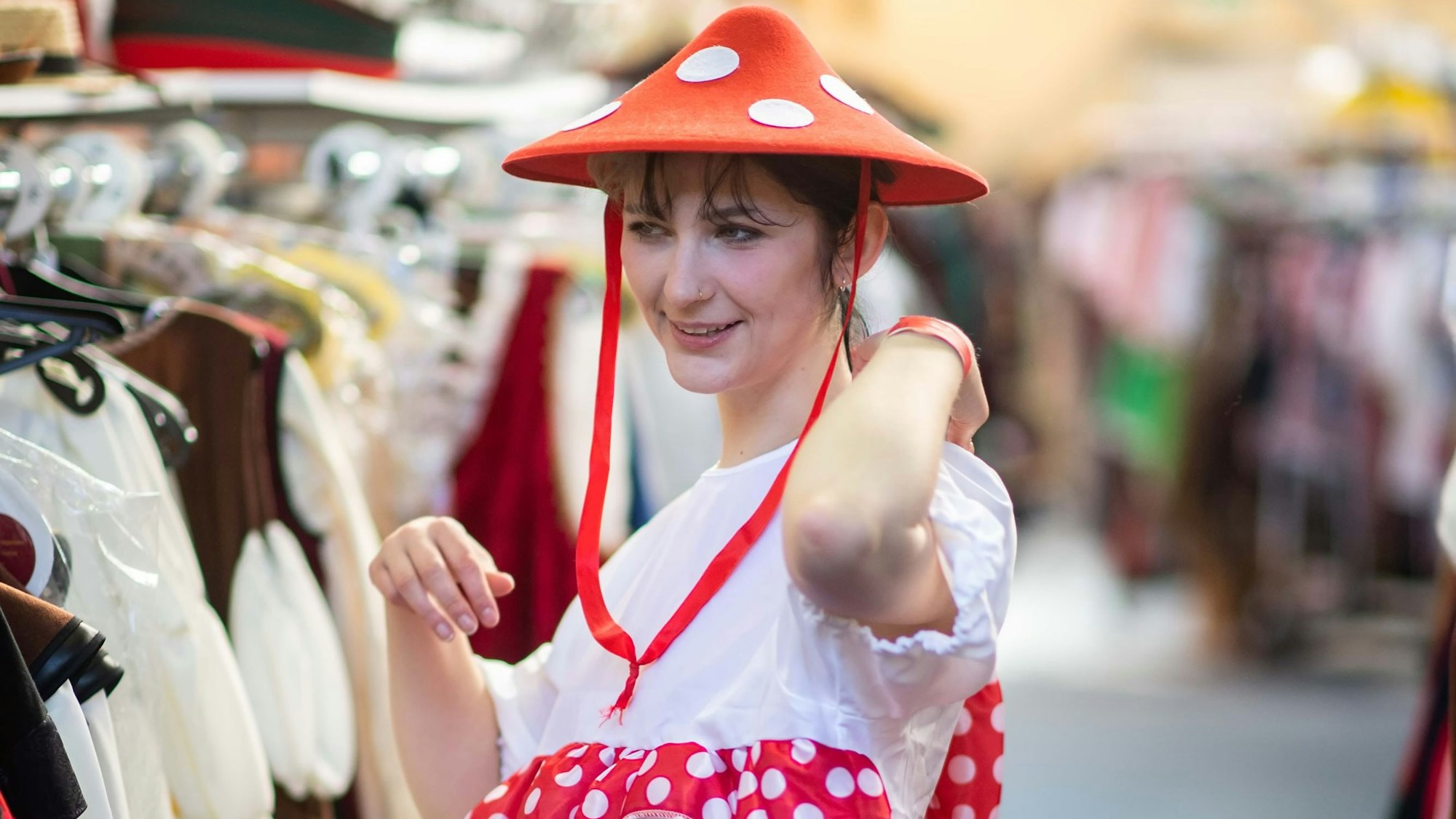 Mit einem rot-weiß gepunkteten Hut und einem weißen Kleid bekleidet mimt Elena Pintus einen Fliegenpilz.