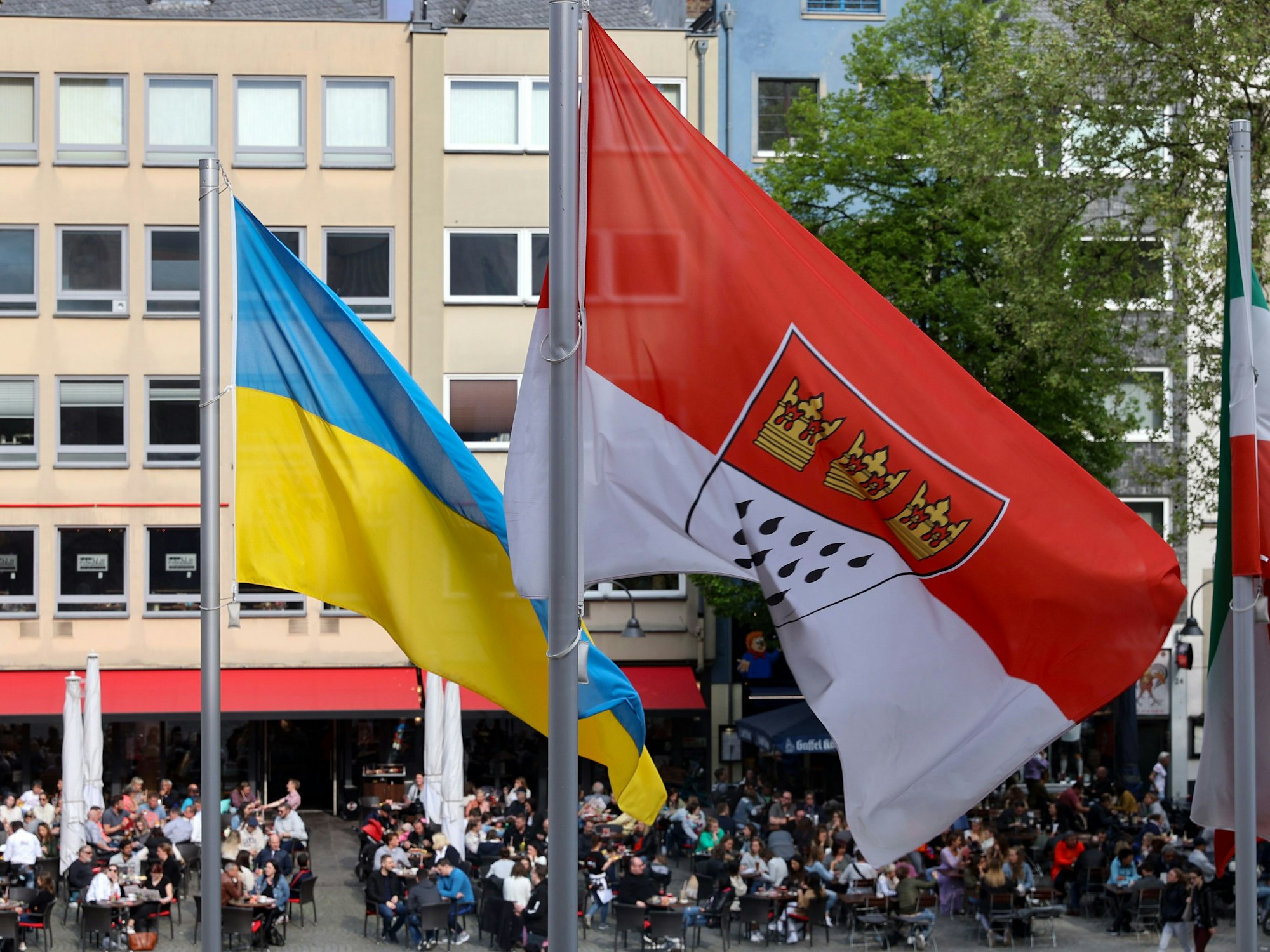 Ukrainische Fahne und die der Stadt Köln wehen vor dem Rathaus.