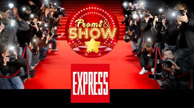Fotografen am roten Teppich, auf dem das Logo des EXPRESS und von Promi &amp; Show zu sehen sind.