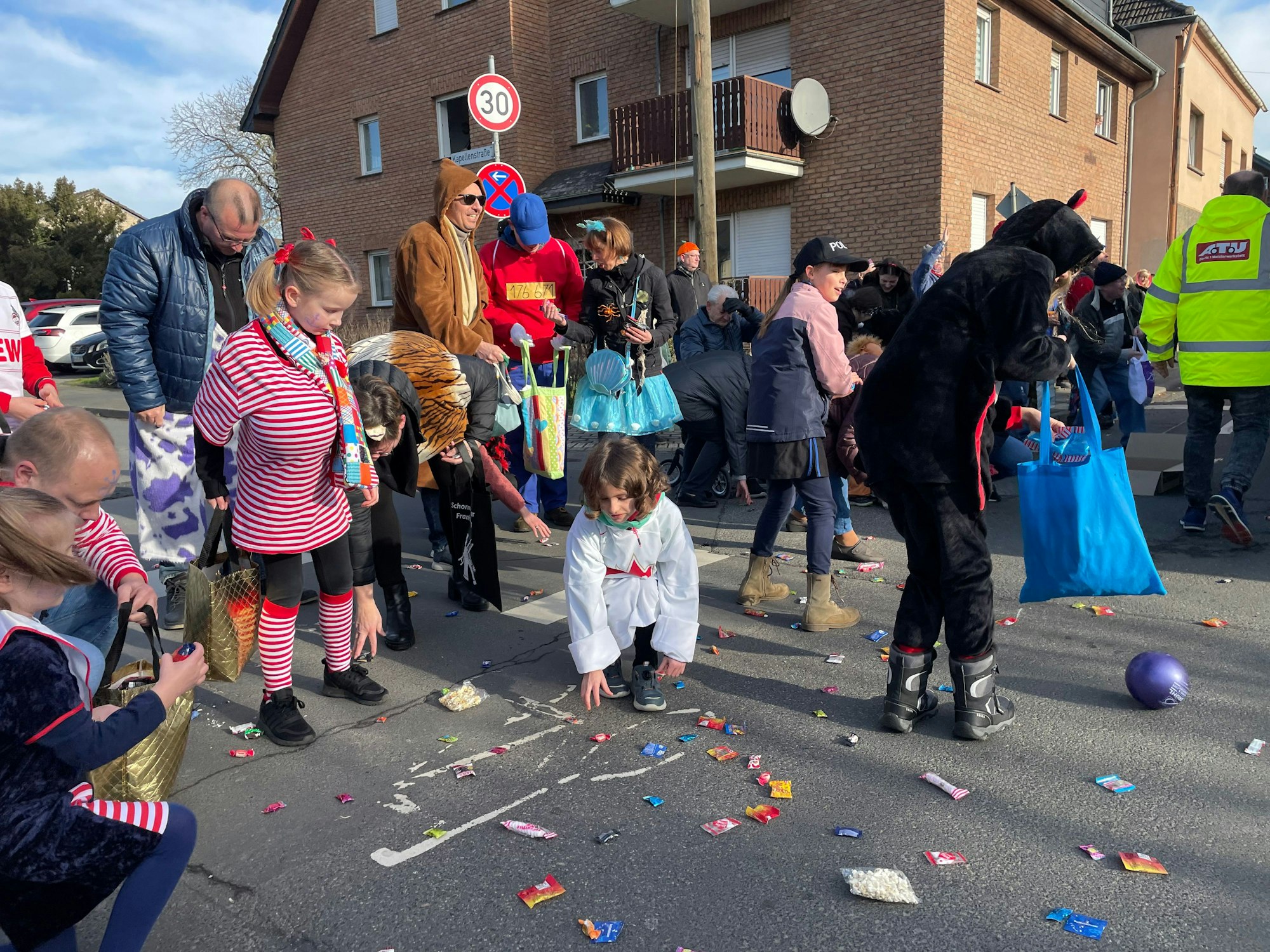 Kinder sammeln Kamelle bei einem Karnevalszug in Troisdorf.