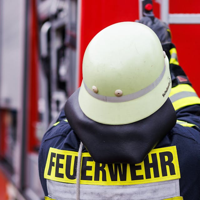 Ein Feuerwehrmann holt während einer Einsatzübung eine Leiter vom Dach eines Einsatzfahrzeugs.&nbsp;