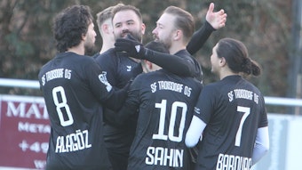 Torschütze Marcel Wiemer lächelt und nimmt die Glückwünsche seiner Teamkollegen mit offenen Armen entgegen.