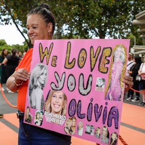 Justine Edwards mit einem Olivia-Plakat.