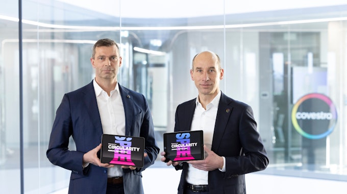 Die Covestro-Vorstände Markus Steilemann (links) und Thomas Töpfer mit dem digitalen Geschäftsbericht für das Jahr 2022