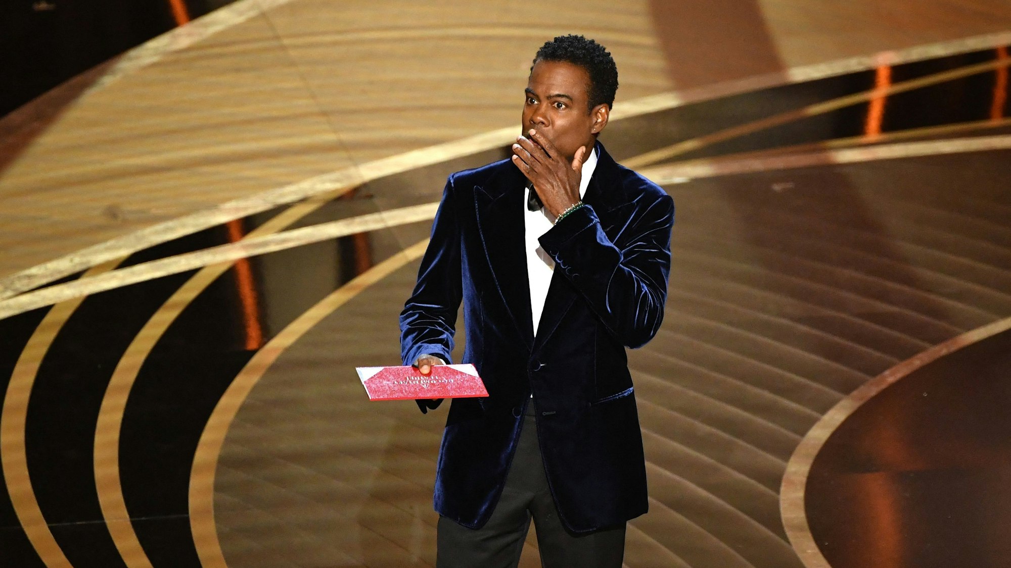 (FILES) In this file photo taken on March 27, 2022 US actor Chris Rock speaks onstage during the 94th Oscars at the Dolby Theatre in Hollywood, California. - Chris Rock finally hit back at Will Smith on March 4, 2023 in a brutal stand-up routine, a year after the actor slapped him in front of a global TV audience for the Oscars. (Photo by Robyn Beck / AFP)