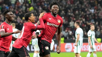 Leverkusen's Edmond Tapsoba, centre, celebrates after scoring his side's second goal during the Europa League Round of 16 first leg soccer match between Bayer Leverkusen and Ferencvaros in Leverkusen, Germany, Thursday, March 9, 2023. (AP Photo/Martin Meissner)