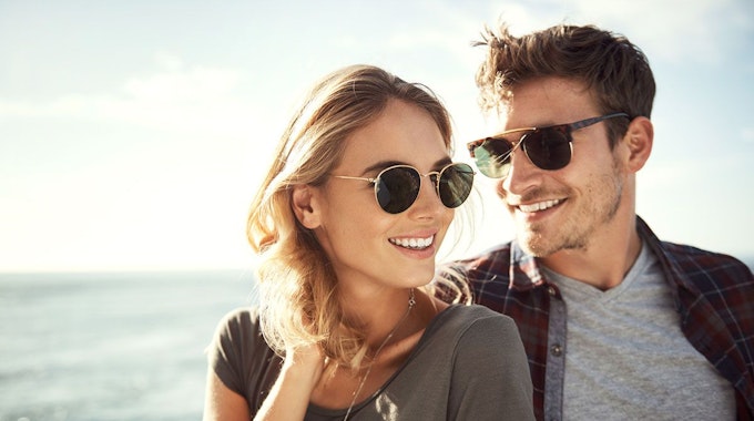 Junges Paar am Strand mit Sonnenbrille auf