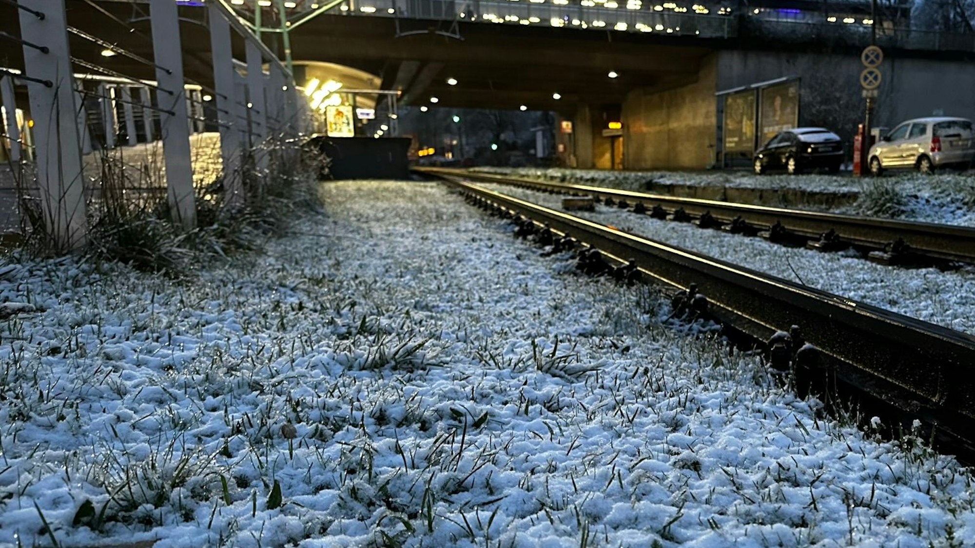 Ein Grünstreifen an der KVB-Haltestelle Amsterdamer Straße/Gürtel in Köln ist mit etwas Schnee bedeckt. In der Nacht zu Mittwoch hat es in Köln geschneit.
