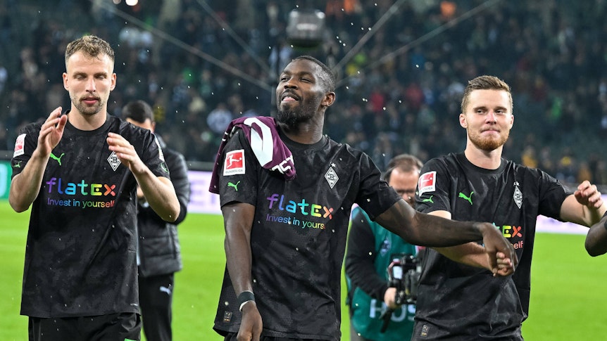 Marcus Thuram (M.) feiert mit Marvin Friedrich (l.) und Nico Elvedi, Thurams Teamkollegen bei Borussia Mönchengladbach, den Bundesliga-Sieg am 11. November 2022 gegen Borussia Dortmund. Seit der WM-Pause läuft es für den Gladbach-Torjäger nicht mehr.