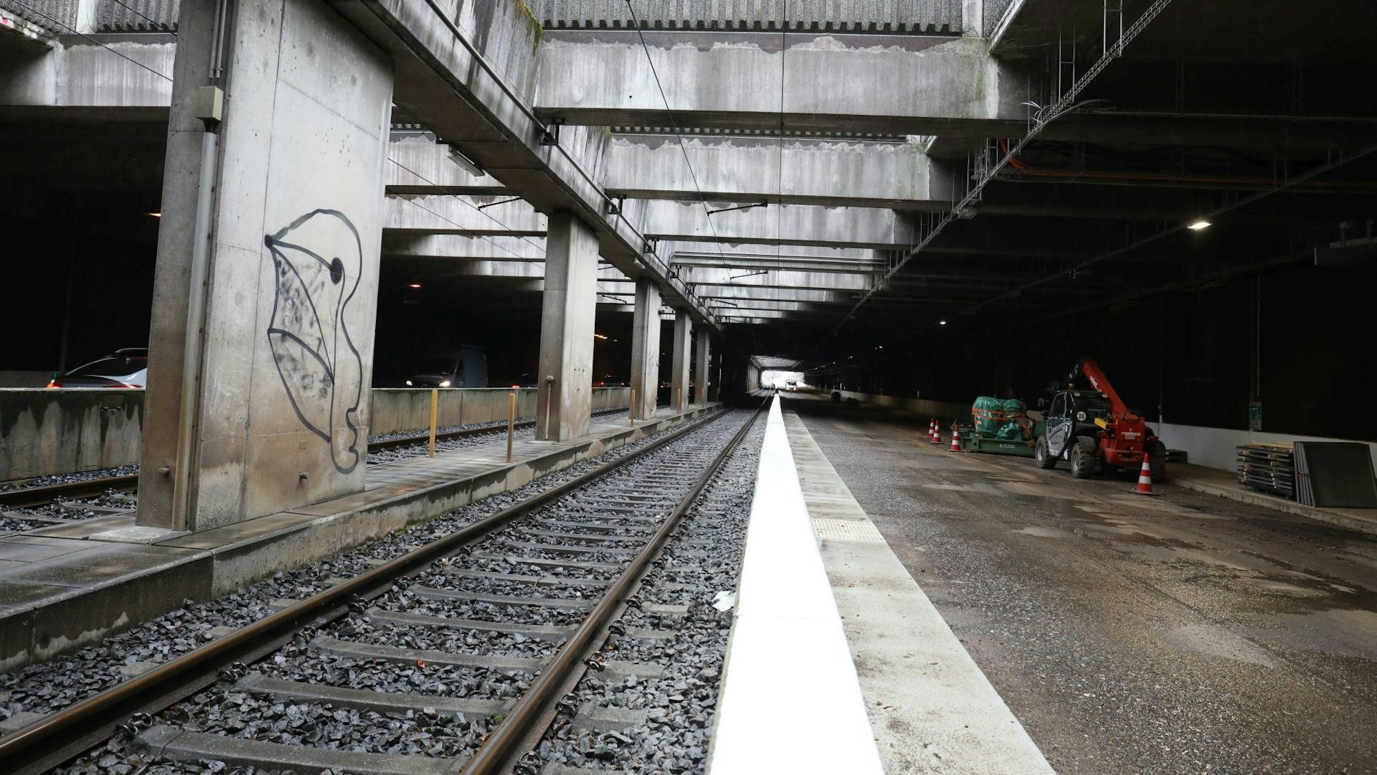 Baumaschinen stehen rechts am Rand des Tunnels Oberdollendorf, durch den auch die Gleise der Stadtbahnlinie 66 führen.