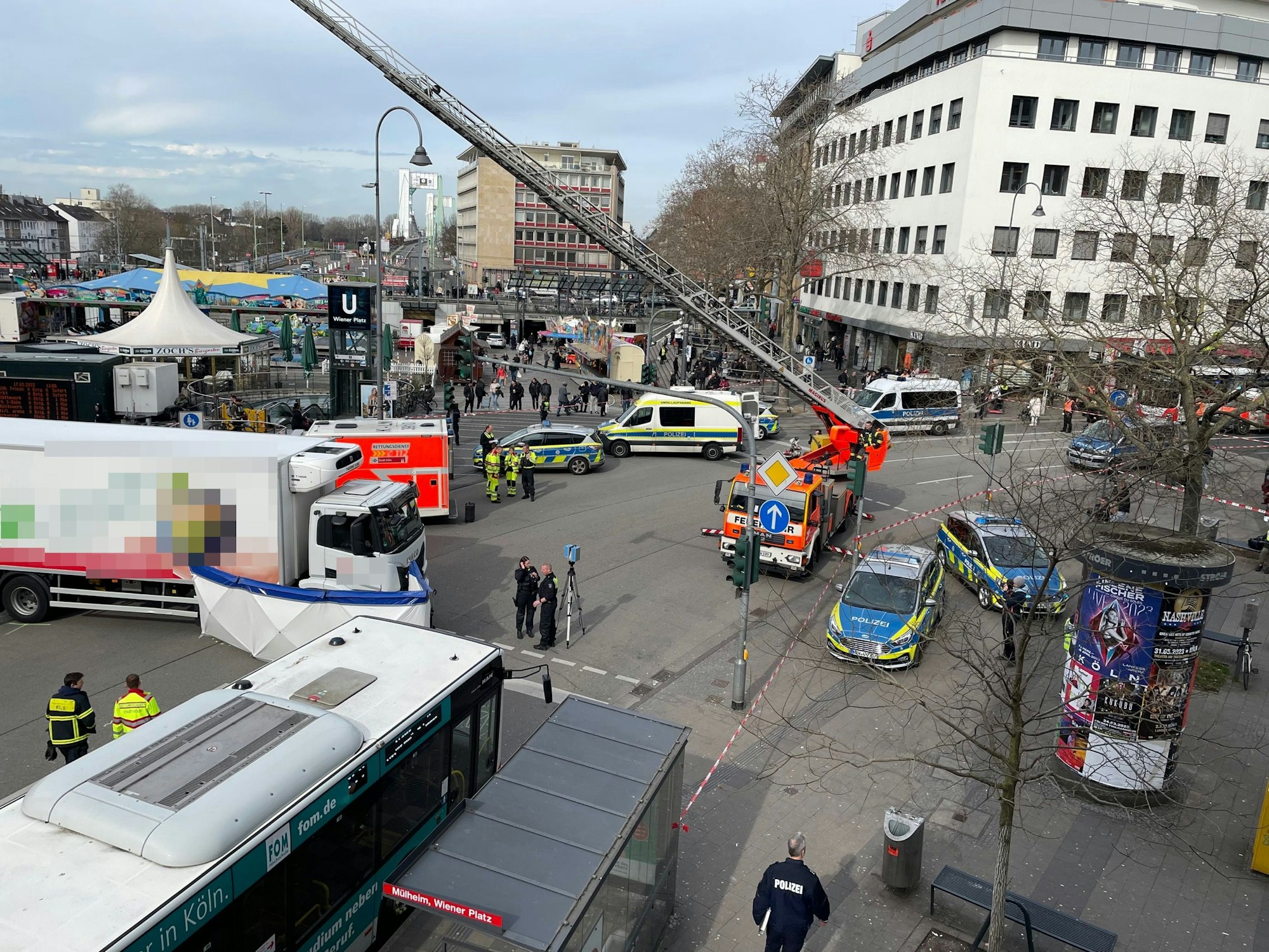 Eine Person ist nach einem Unfall in Köln-Mülheim am Freitagmorgen gestorben. Einsatzkräfte stehen am Wiener Platz.