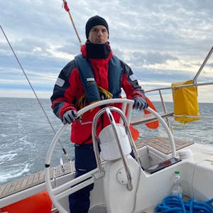 Roman Salyutov steht am Steuer eines Segelboots.