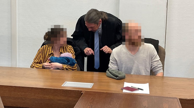 Die Angeklagten mit Baby und Verteidiger Ingo Lindemann beim Prozess vor dem Kölner Amtsgericht.