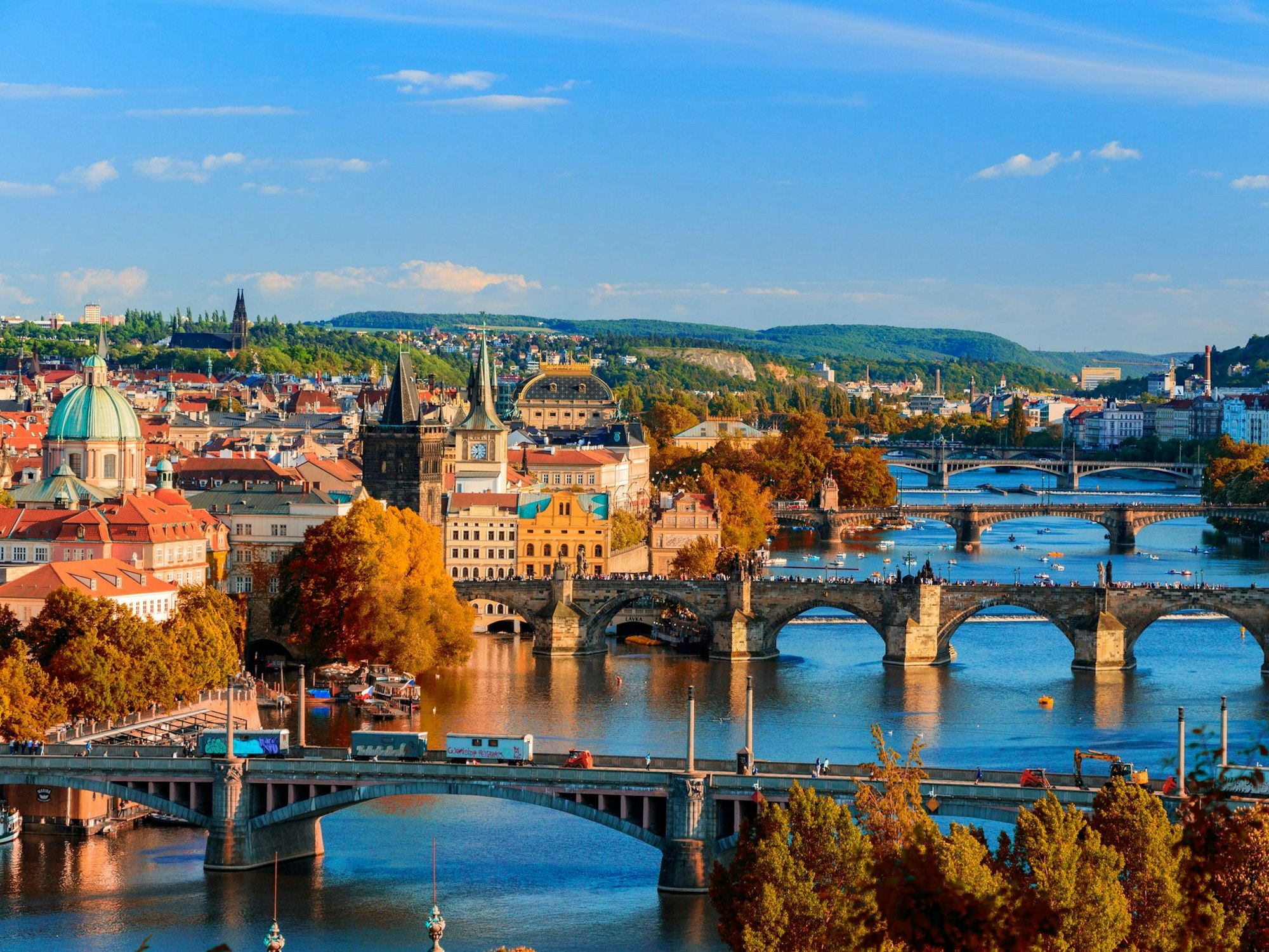 View of the Vltava River and Charle bridge with red foliage, Prague, Czech Republic