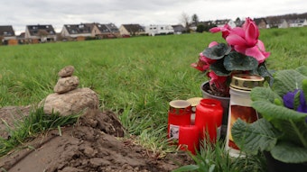 Blumen und Kerzen sind an der Unfallstelle aufgestellt bei Dansweiler aufgestellt worden.