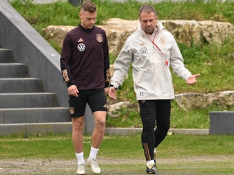 Joshua Kimmich (l) und Bundestrainer Hansi Flick kommen zum Training der deutschen Nationalmannschaft auf den Trainingsplatz des DFB-Campus.