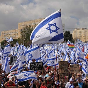 Menschen protestieren mit Flaggen vor dem israelischen Parlament in Jerusalem.