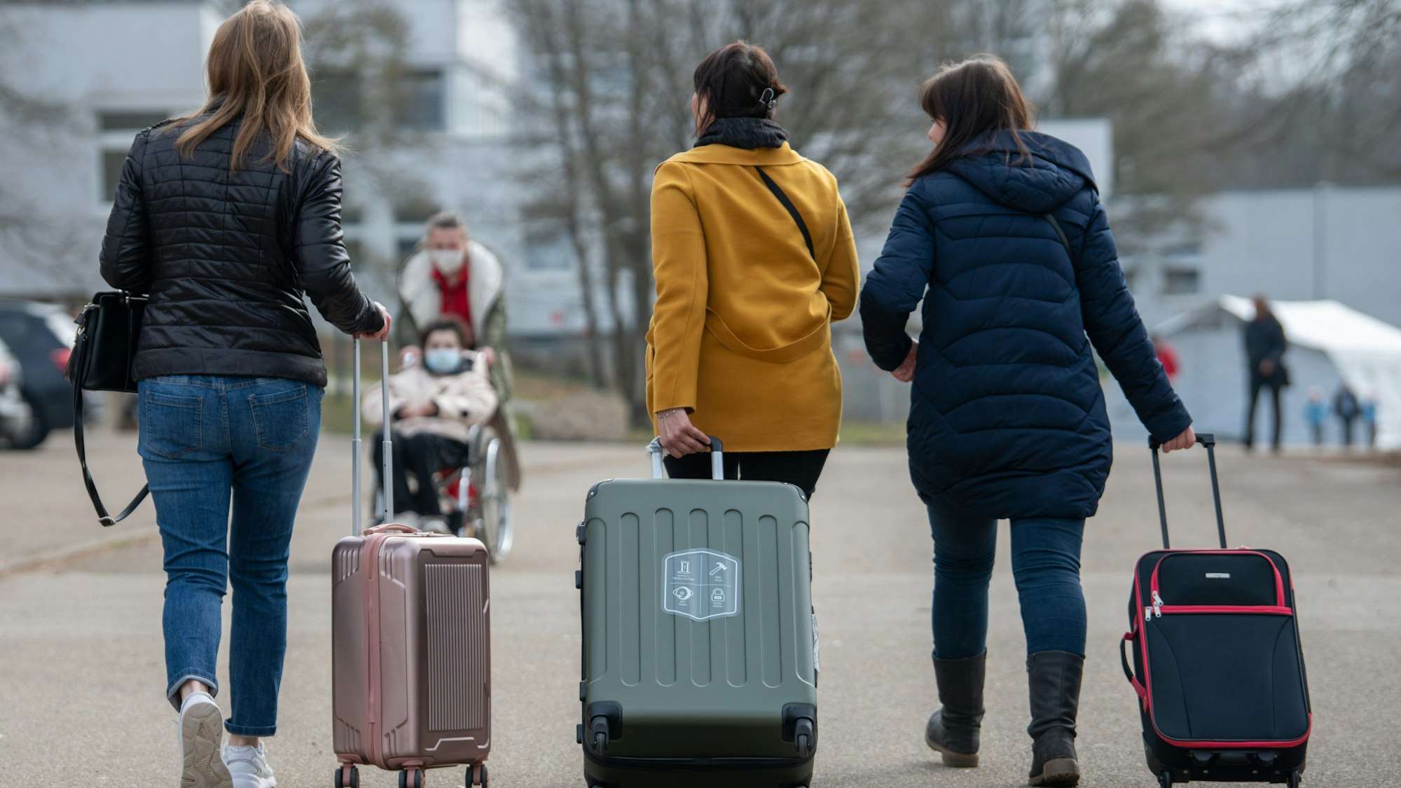 Drei aus der Ukraine stammende Frauen gehen in der Landeserstaufnahmestelle für Flüchtlinge (LEA) zu ihrem Quartier.