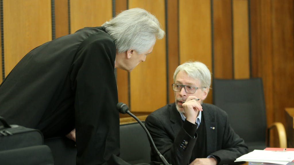 Zwei Anwälte unterhalten sich im Gerichtssaal.