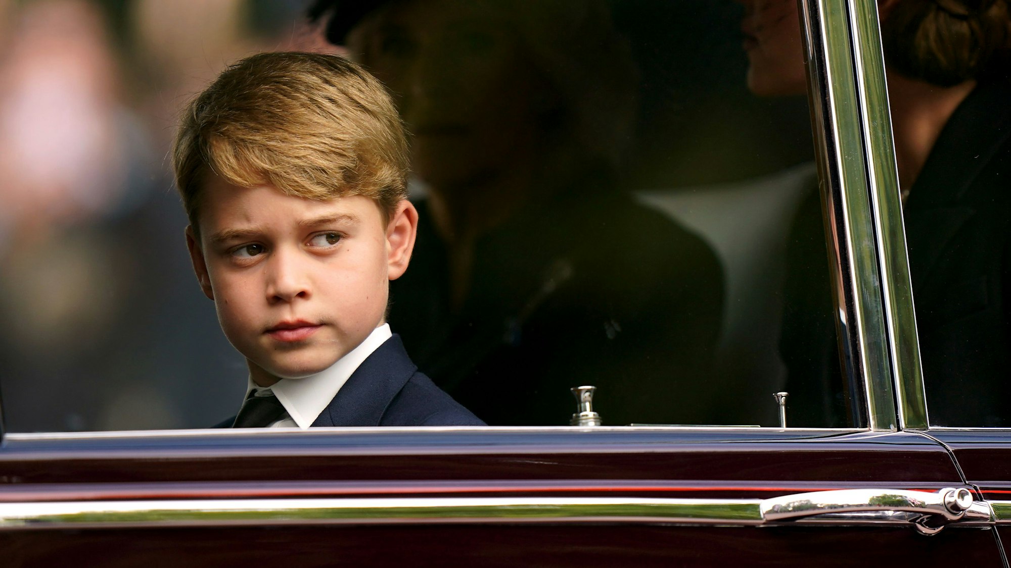 Prinz George sitzt bei der feierlichen Prozession nach dem Staatsakt vor der Beisetzung von Königin Elizabeth II. in einer Limousine.