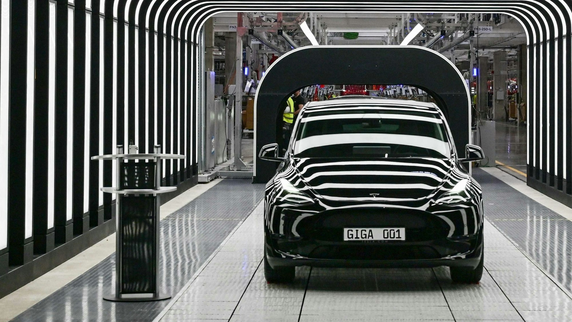 (FILES) In this file photo taken on March 22, 2022, an electric vehicle of the model Y is pictured during the start of the production at Tesla's "Gigafactory" in Gruenheide, southeast of Berlin. - Tesla reported another round of record quarterly profits on January 25, 2023, while confirming its long-term production outlook in spite of concerns about rising competition and macroeconomic headwinds. (Photo by Patrick Pleul / POOL / AFP)