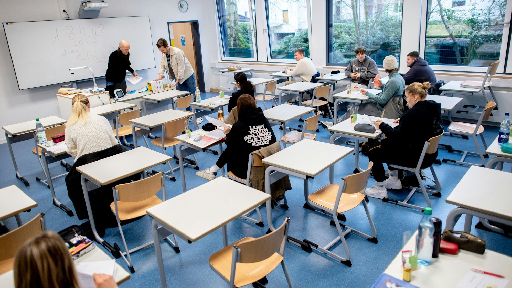 Schüler sitzen vor Beginn der schriftlichen Abiturprüfungen in einem Klassenraum.