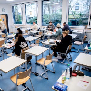 Schüler sitzen vor Beginn der schriftlichen Abiturprüfungen in einem Klassenraum.