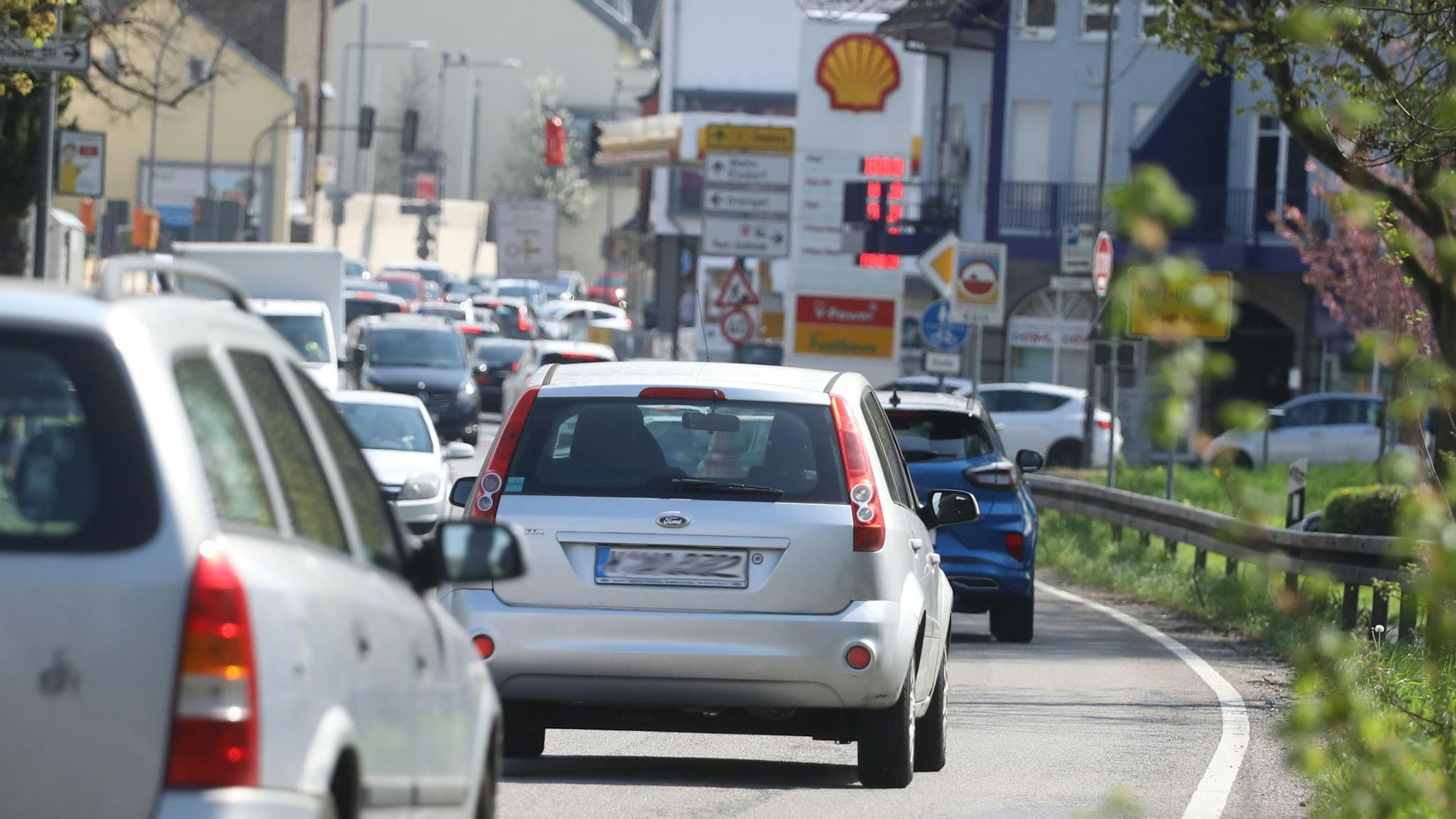 Straße voller Autos mit Blick auf eine Shell-Tankstelle.