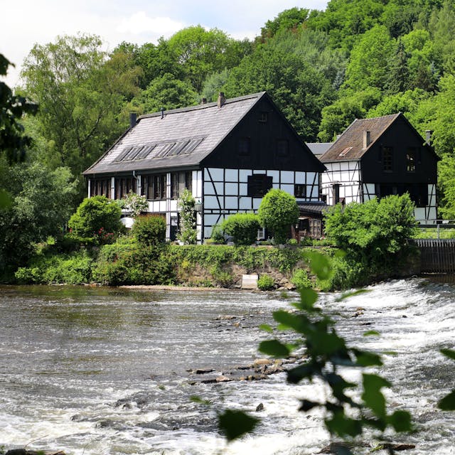 zwei Fachwerkgebäude an einem Fluss