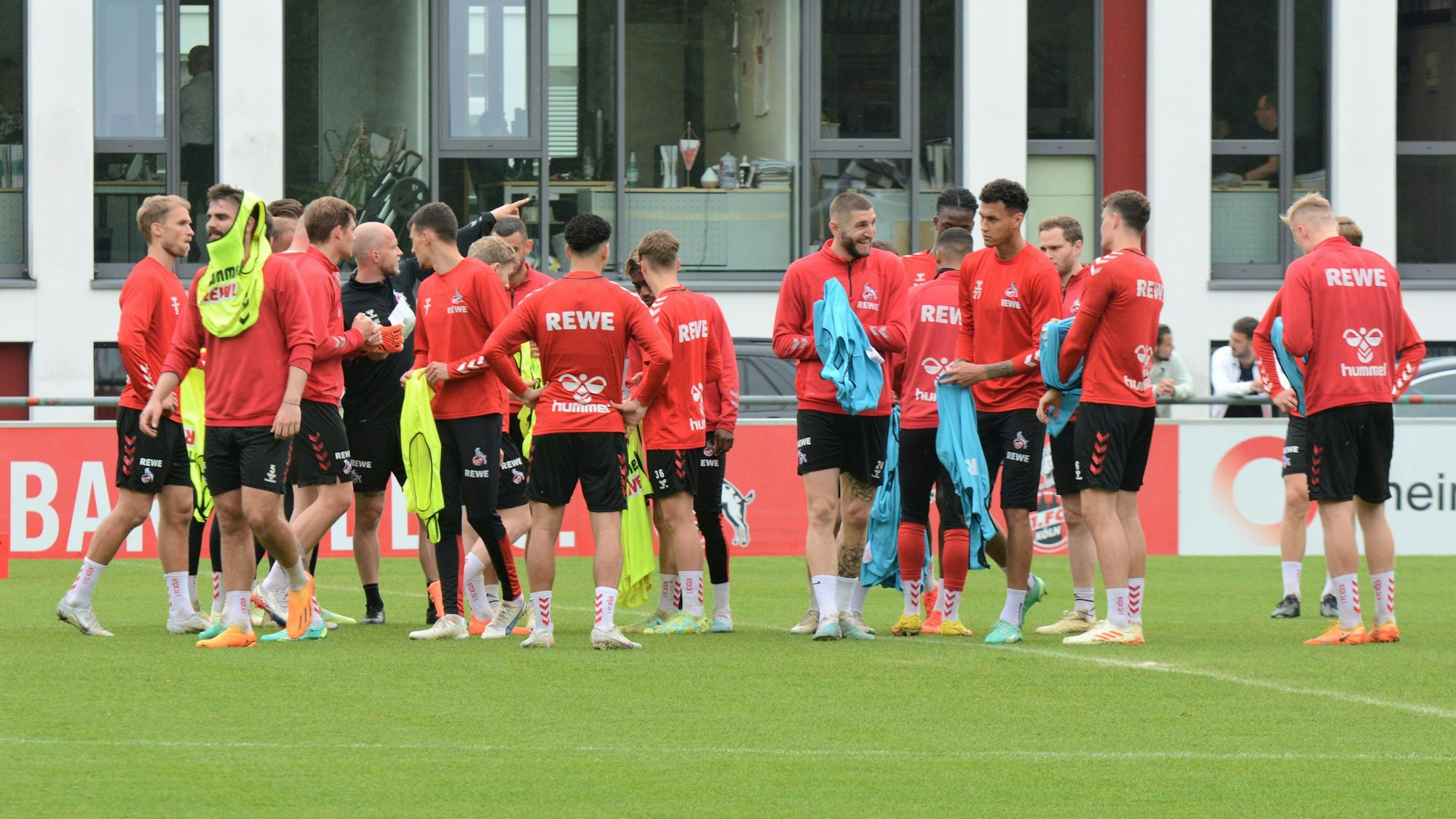 Die Spieler des 1. FC Köln ziehen sich Leibchen über.