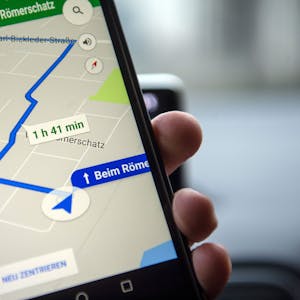 Die Navigationssoftware Google Maps zeigt eine Route auf dem Schirm eines Smartphones. Die Navi-App zeigt auch Straßen an, die es gar nicht gibt, sogenannte Trap Streets. Das steckt dahinter. (Symbolbild)