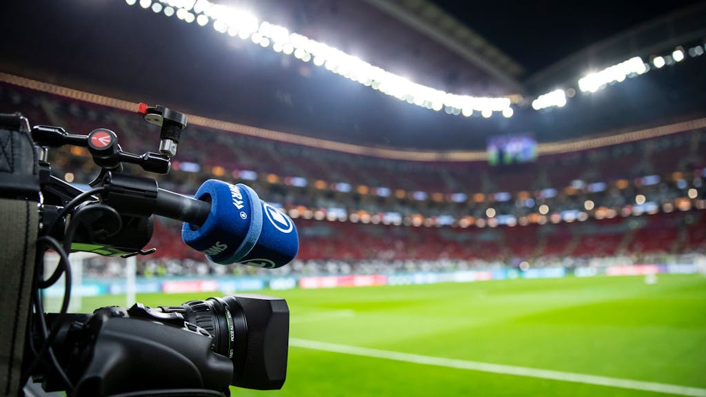Eine TV-Kamera der ARD steht am Spielfeldrand vor dem Spiel.
