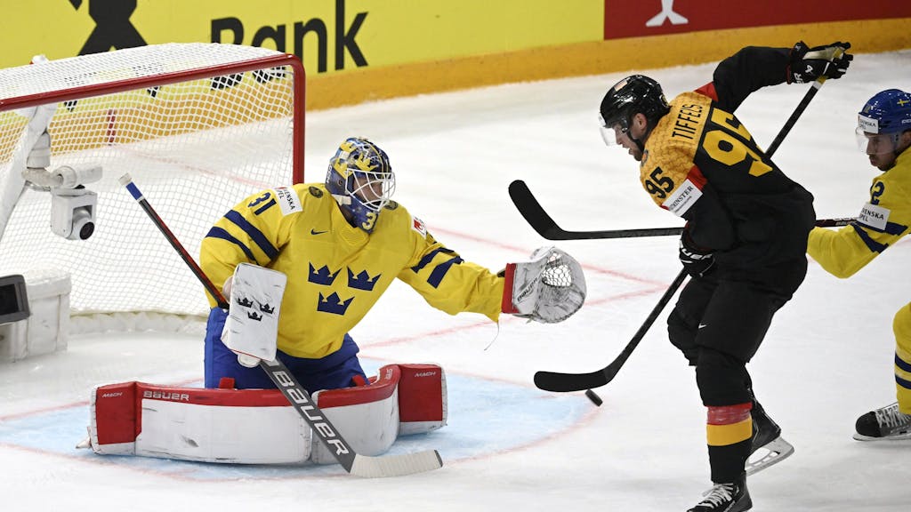 Eishockey-WM: Schweden gegen Deutschland. Frederik Tiffels (r) aus Deutschland gegen Torhüter Lars Johansson aus Schweden.