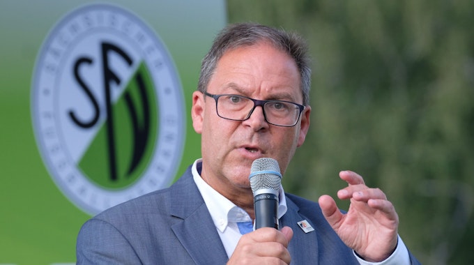 DFB-Vizepräsident Hermann Winkler spricht in ein Mikrofon.