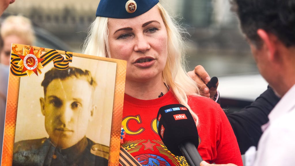 Die prorussische Aktivistin Elena Kolbasnikova hält bei einem Interview ein Foto eines Soldaten aus dem Zweiten Weltkrieg in die Kamera.