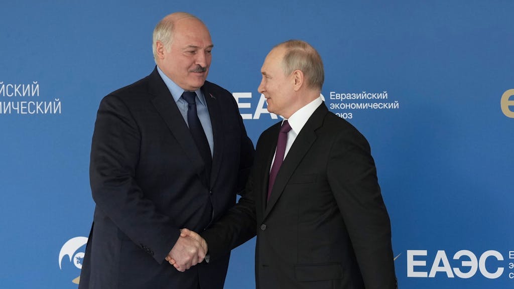 Auf diesem von der Roscongress Foundation veröffentlichten Foto begrüßen sich Wladimir Putin (r), Präsident von Russland, und Alexander Lukaschenko, Präsident von Belarus.