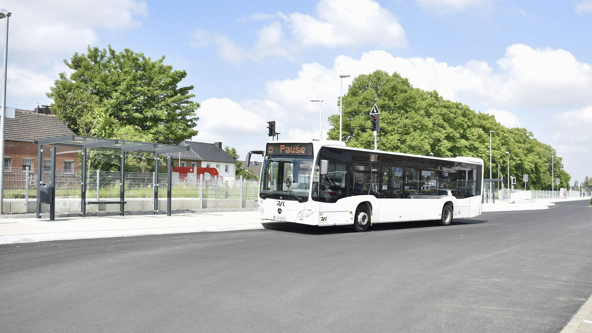 Das Bild zeigt den neuen Zülpicher Busbahnhof. Ein weißer Bus steht an einer Haltestelle.