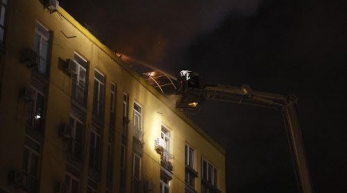 Feuerwehrleute löschen in Kyjiw ein Feuer auf dem Dach eines Wohnhauses nach einem Drohnenangriff. Das Foto wurde Samstagnacht (20. Mai) aufgenommen.