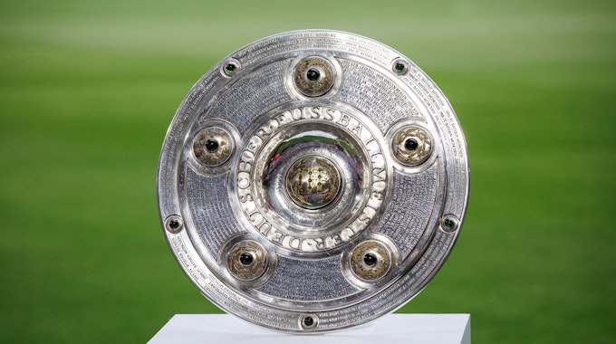 Die Meisterschale der Bundesliga steht auf dem Rasen.
