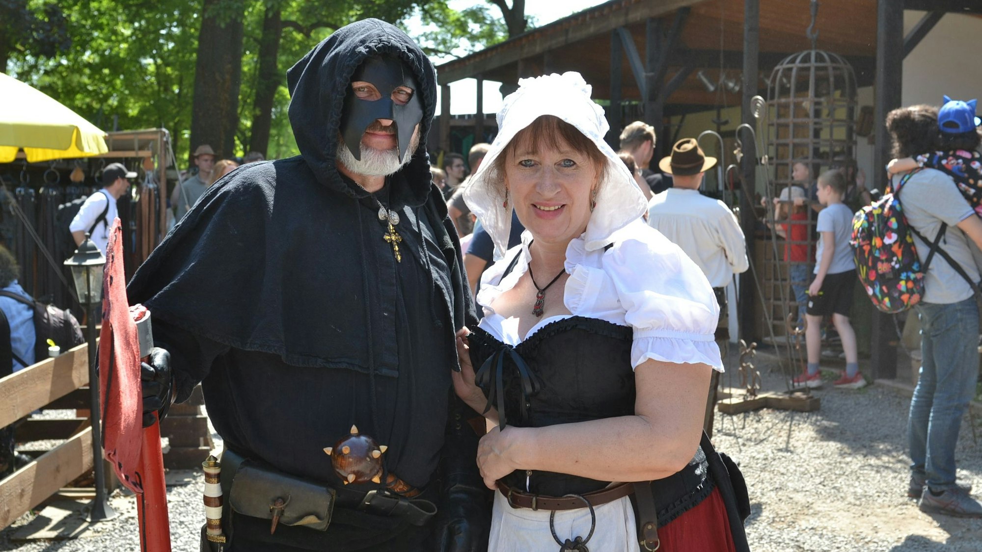 Das Bild zeigt verkleidete Teilnehmer der Ritterfestspiele: Ein Mann ist als Scharfrichter, eine Frau als Schankmaid.