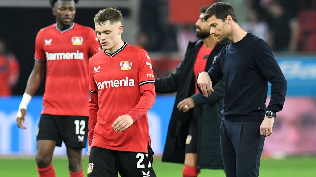 Florian Wirtz (l.) und Bayer-Trainer Xabi Alonso wirken niedergeschlagen.