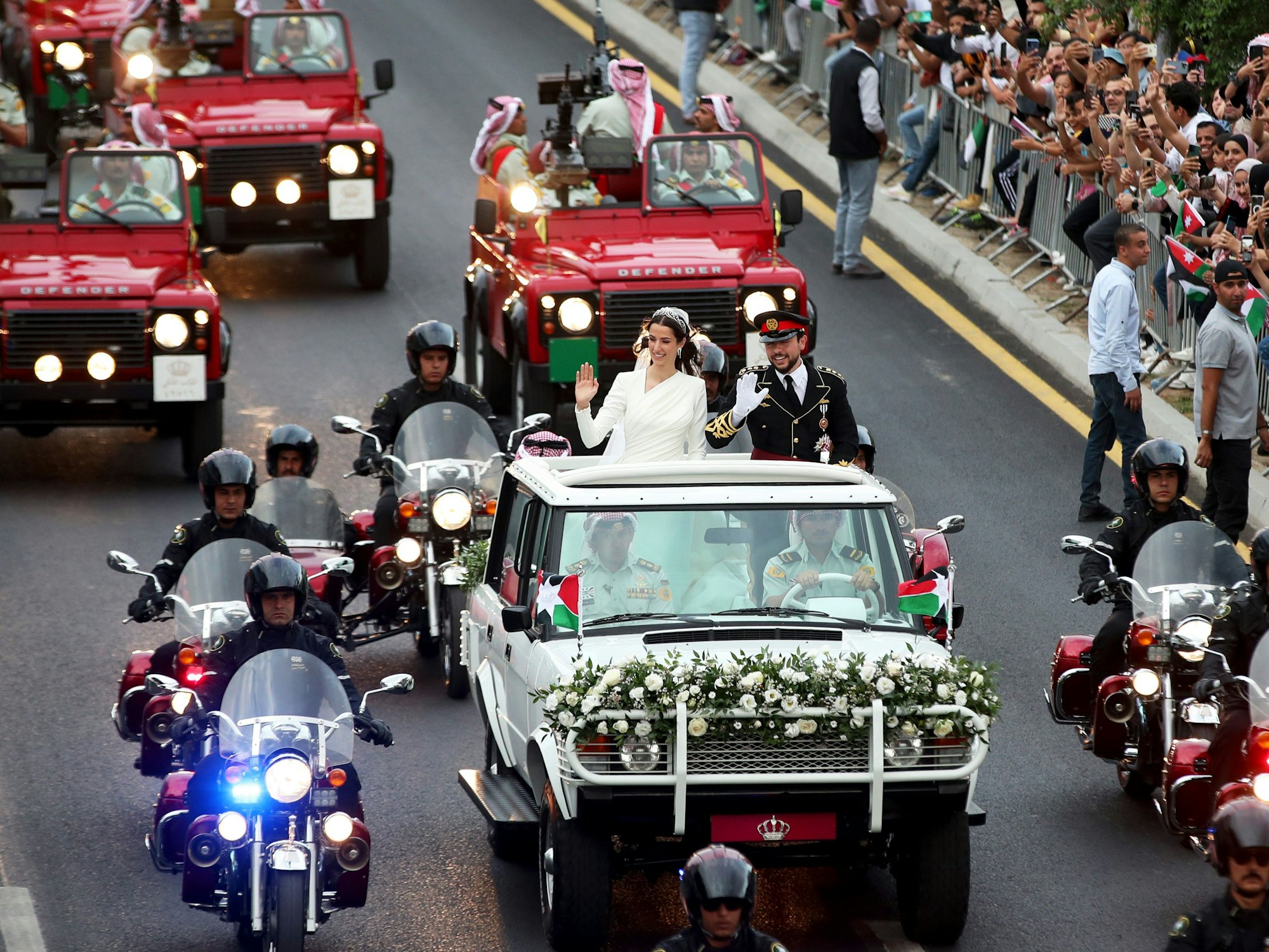 Rajwa Al Saifund der jordanische Kronprinz Hussein bin Abdullah II fahren anlässlich ihrer Hochzeit in einem offenen Wagen durch Amman.