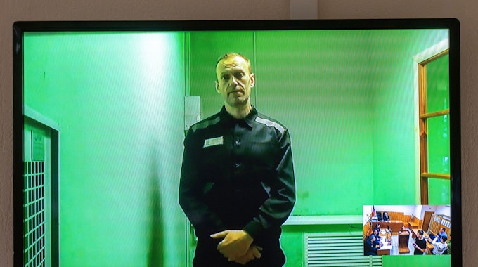 Der russische Oppositionsführer Alexej Nawalny spricht in einer von der russischen Strafvollzugsbehörde bereitgestellten Videoübertragung, aus dem Gefängnis. Ein Foto zeigt einen Fernsehbildschirm, auf dem er zu sehen ist.
