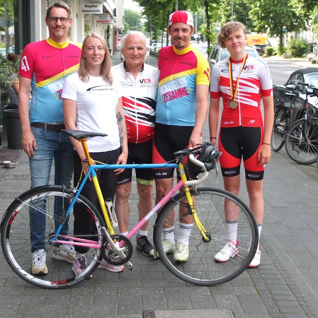 Christoph Kothen, Melanie Schmidt, Artur Tabat, Oliver Zillger und Annamaria Borger stehen vor einem Sportrad.