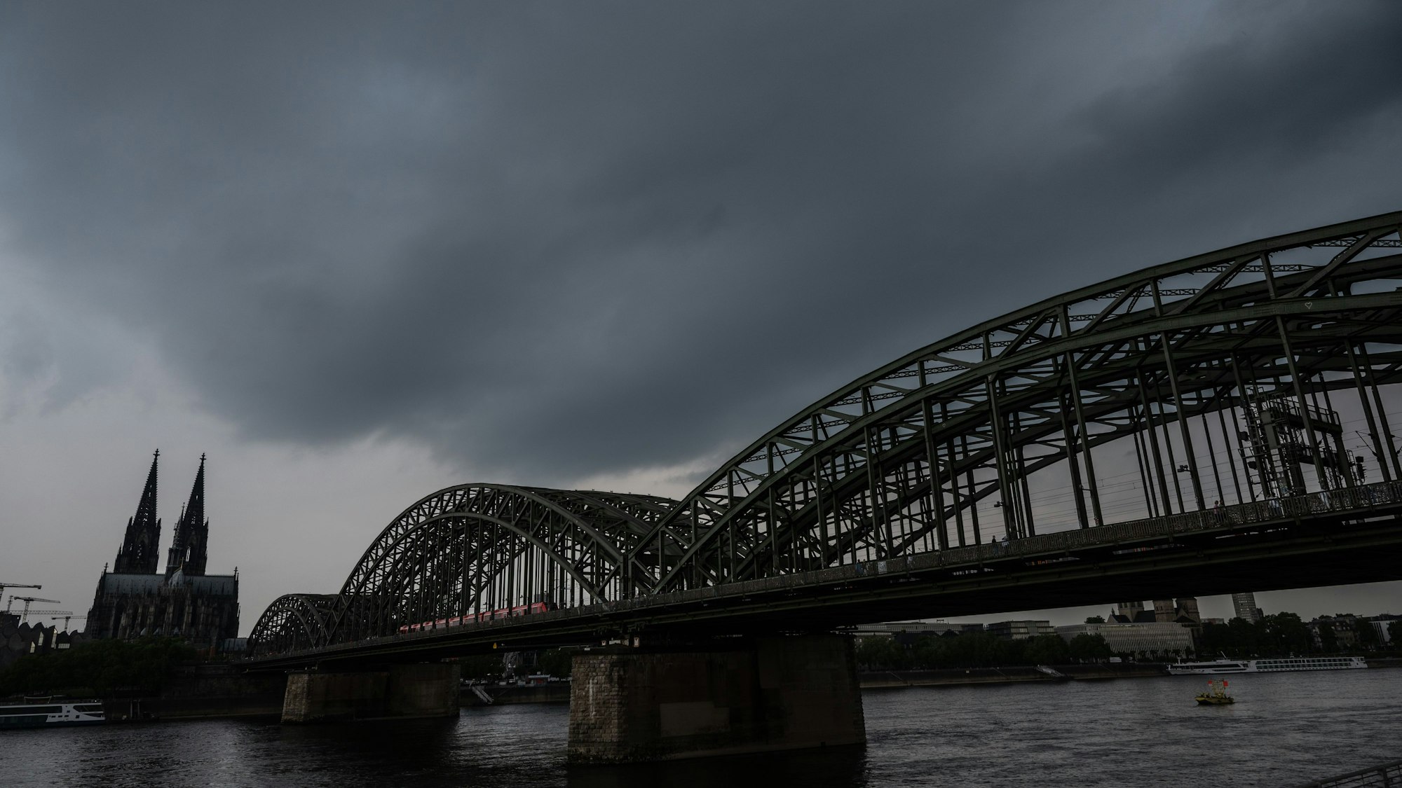 Dunkle Gewitterwolken ziehen über dem Dom auf. Der Deutsche Wetterdienst warnt vor schweren Gewittern im Rheinland.