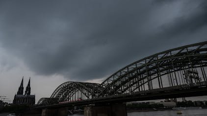 Dunkle Gewitterwolken ziehen über dem Dom auf. Der Deutsche Wetterdienst warnt vor schweren Gewittern im Rheinland.